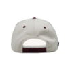Back view of "The Heritage Snapback", showing an adjustable snapback strap and cream structured panels.
