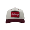 Front view of "The Heritage Snapback", showing a centered red patch logo and structured cream panels.
