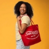 Sargento Heritage Tote Bag worn over the shoulder in red with white Sargento logo and “Est. 1953” heritage graphic