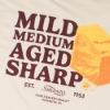 Close-up of Sargento Cheddar Lineup Tee back graphic with cheddar block and Mild, Medium, Aged, Sharp text